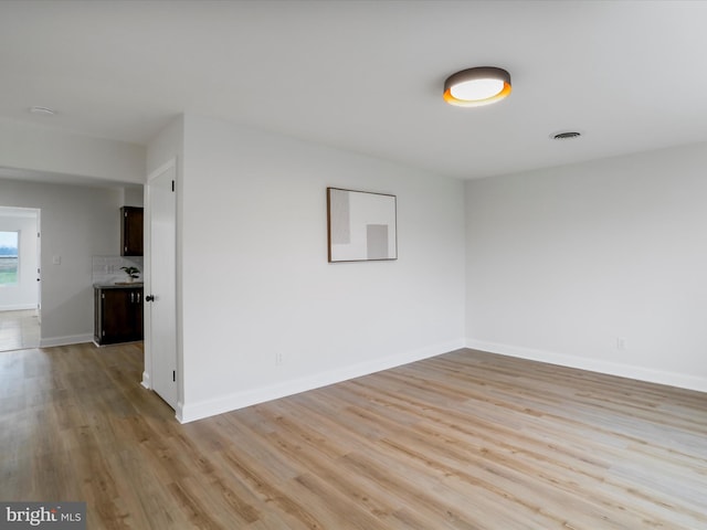 spare room featuring light wood-type flooring and sink