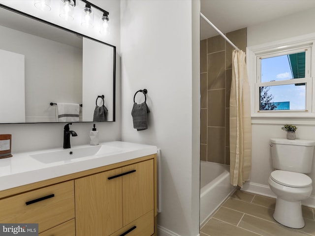 full bathroom featuring tile patterned floors, shower / tub combo with curtain, vanity, and toilet