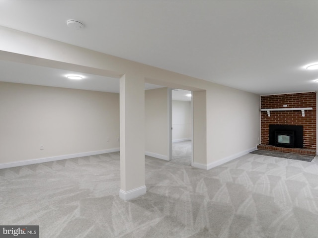 basement featuring a fireplace and light colored carpet