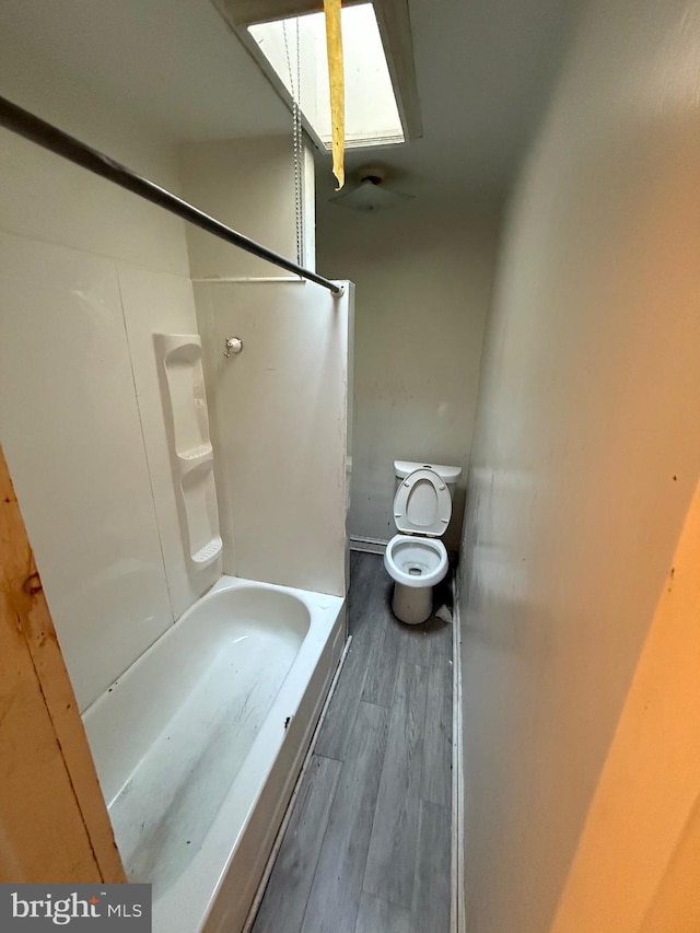 bathroom featuring wood-type flooring and toilet