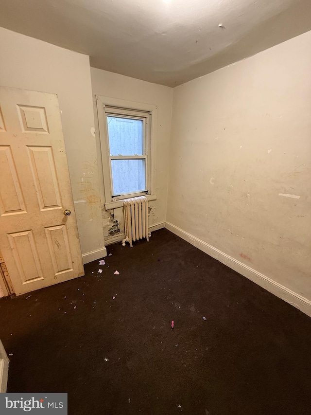 unfurnished bedroom featuring radiator