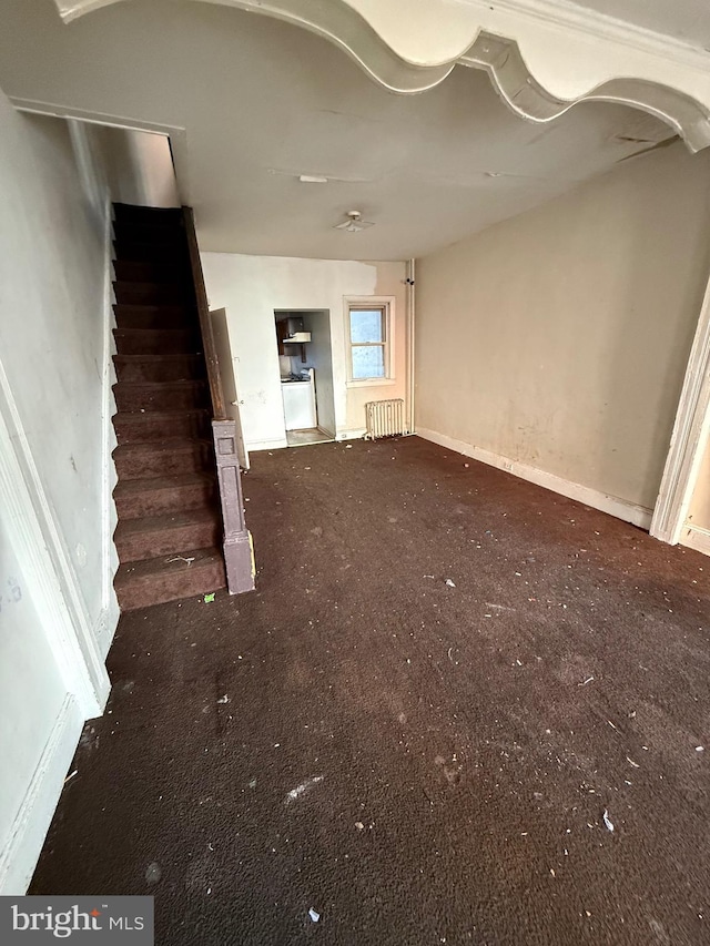 unfurnished living room featuring radiator