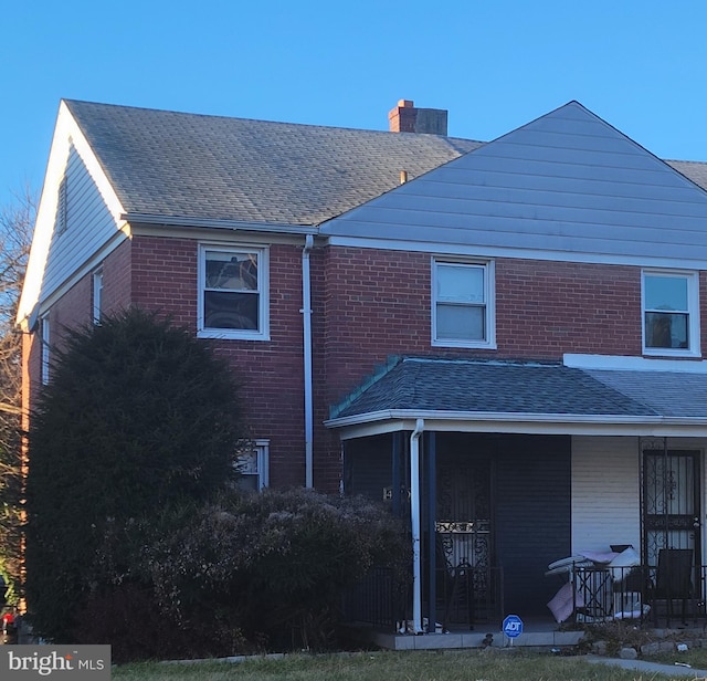 rear view of property featuring a porch