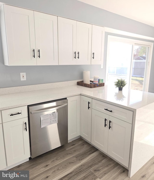 kitchen featuring dishwasher, light wood-type flooring, and white cabinetry