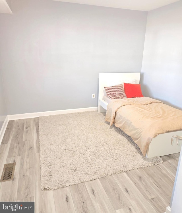 bedroom with hardwood / wood-style flooring