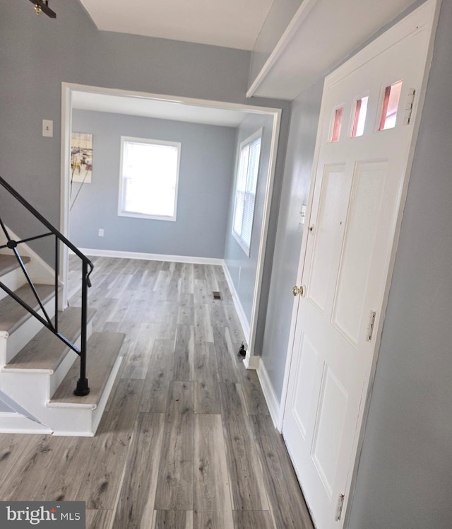 entryway with hardwood / wood-style floors