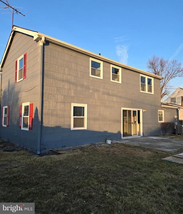 back of property featuring a yard and a patio