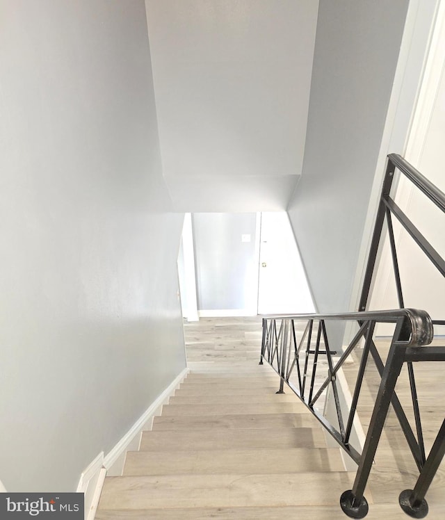 stairs featuring hardwood / wood-style flooring