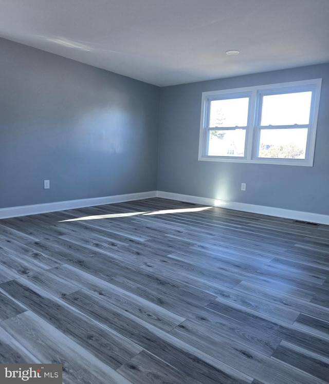 unfurnished room featuring dark hardwood / wood-style floors