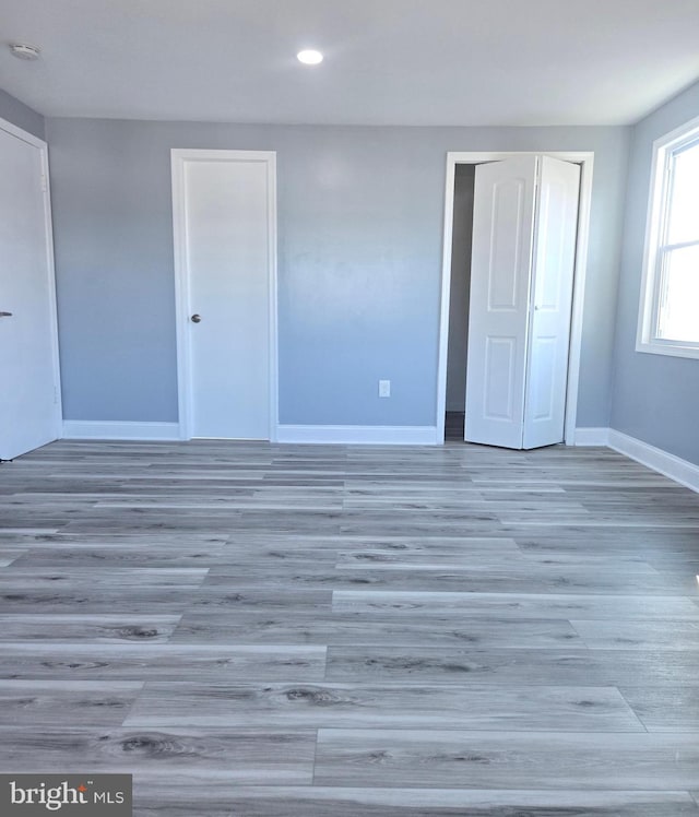 unfurnished bedroom featuring hardwood / wood-style flooring and a closet