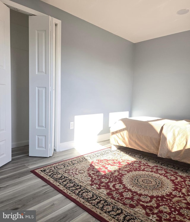 bedroom with wood-type flooring