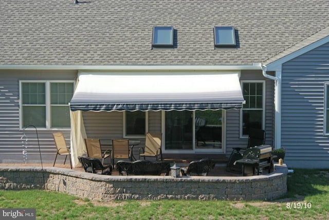 rear view of property featuring a patio area