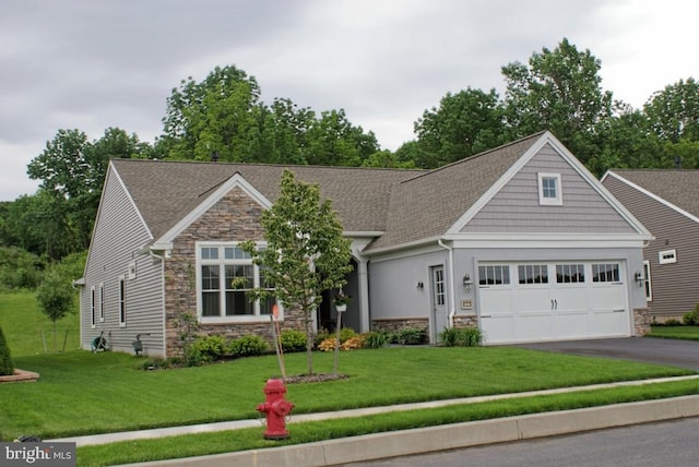 craftsman-style home featuring a garage and a front lawn