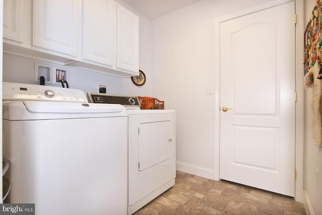 laundry area with washer and dryer and cabinets