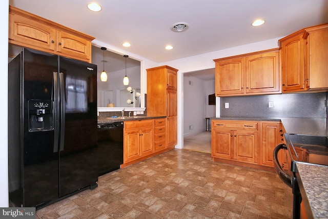 kitchen featuring hanging light fixtures, decorative backsplash, and black appliances