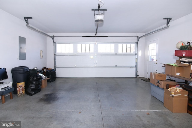 garage with a garage door opener and electric panel