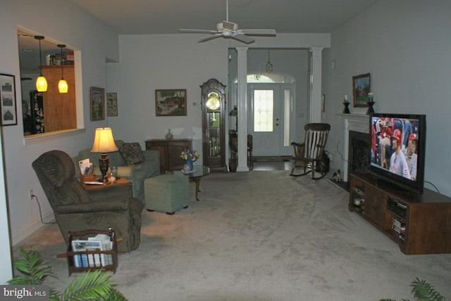 living room featuring decorative columns, ceiling fan, and carpet flooring