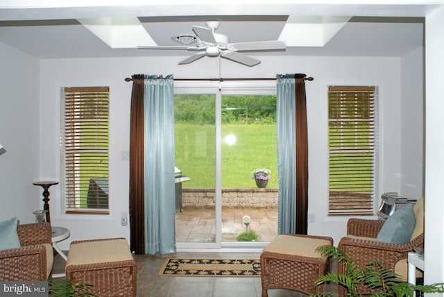 doorway with ceiling fan, tile patterned floors, and plenty of natural light