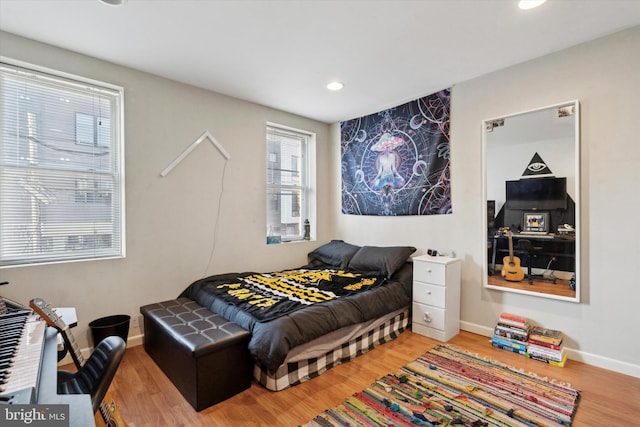 bedroom with hardwood / wood-style flooring