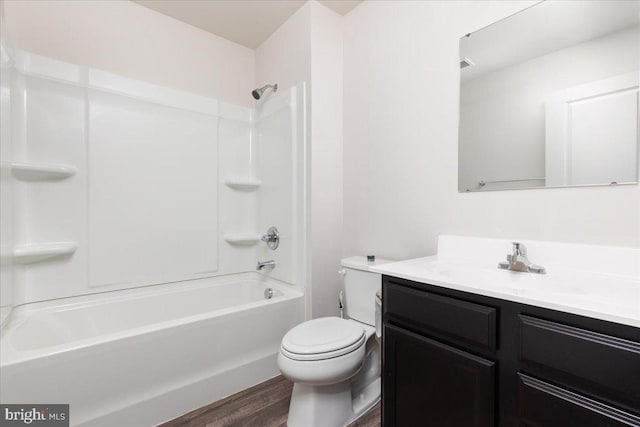 full bathroom featuring hardwood / wood-style flooring, vanity, shower / bath combination, and toilet