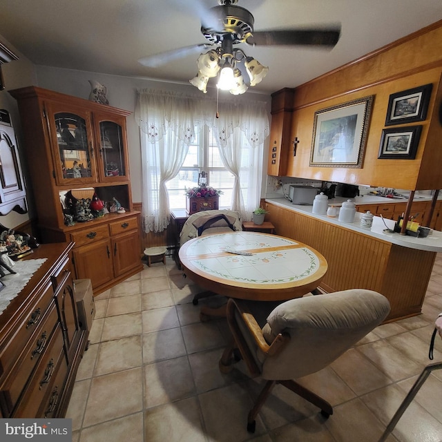 tiled dining area with ceiling fan