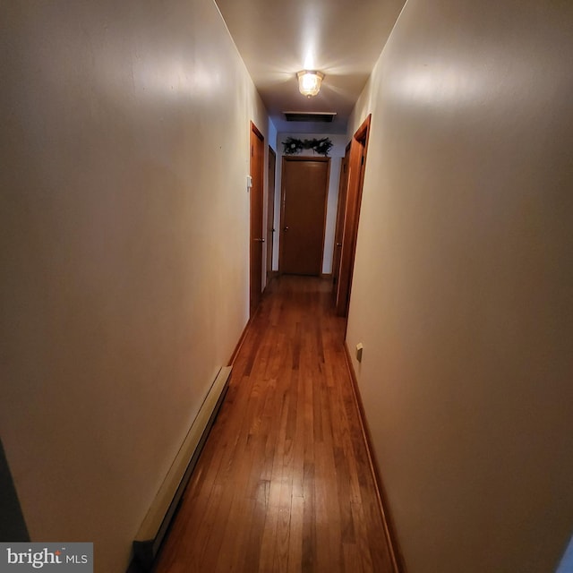 hall with light wood-type flooring and baseboard heating