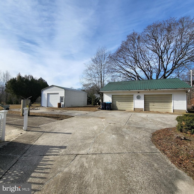 view of home's exterior with an outdoor structure and a garage