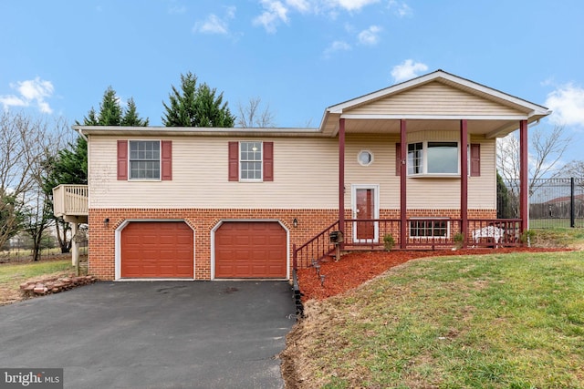 bi-level home featuring a front yard and a garage