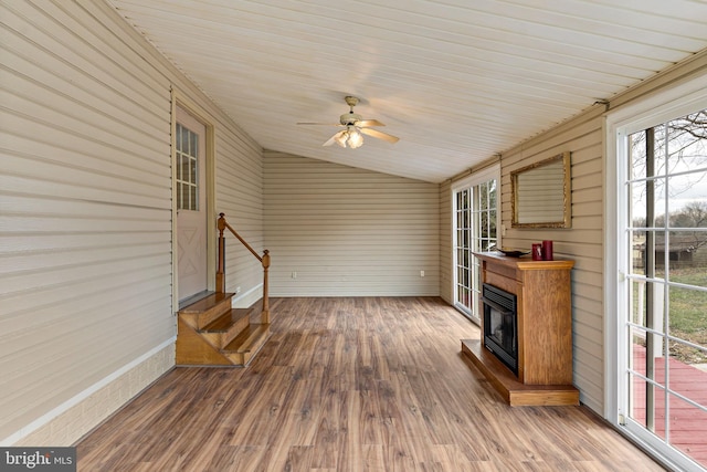 sunroom / solarium with ceiling fan and vaulted ceiling