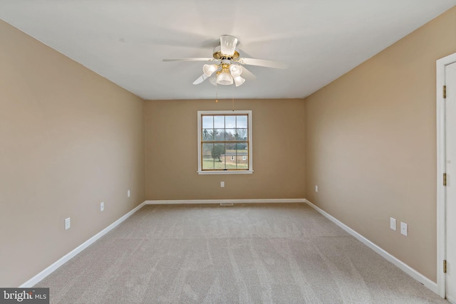 carpeted spare room with ceiling fan