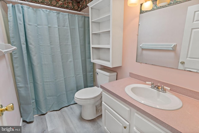 bathroom featuring a shower with shower curtain, wood-type flooring, vanity, and toilet