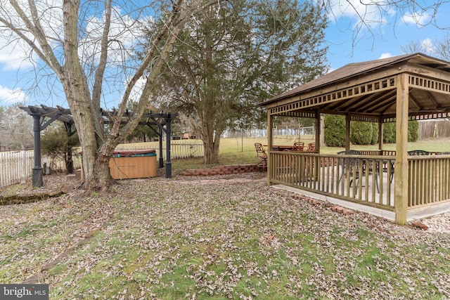 view of yard with a gazebo, a hot tub, and a deck