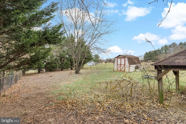 view of yard featuring a rural view and a storage unit