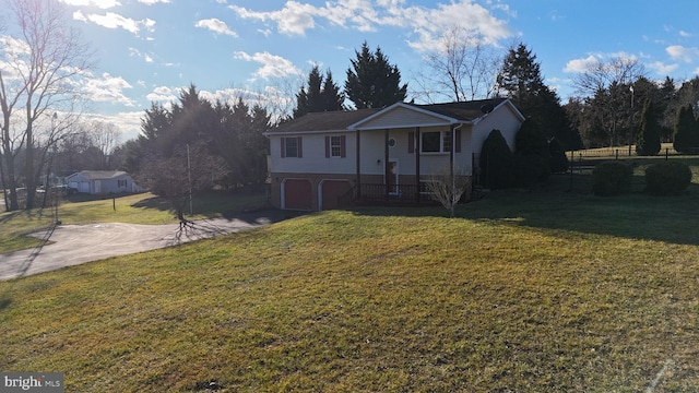 view of front facade with a porch, a garage, and a front lawn