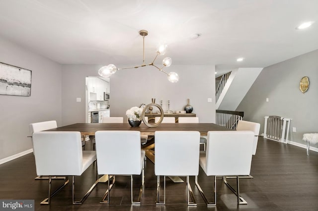 dining space featuring dark hardwood / wood-style flooring and a notable chandelier