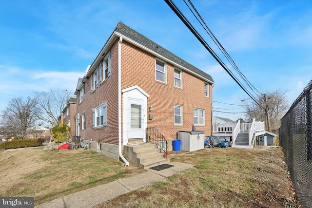 rear view of house with a yard