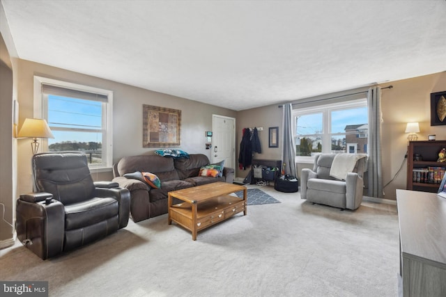 living room featuring light colored carpet and plenty of natural light