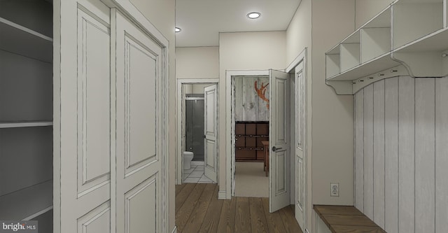 walk in closet with hardwood / wood-style flooring