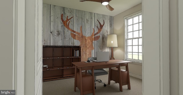 carpeted office space featuring ceiling fan