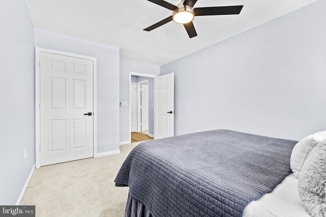 bedroom featuring light colored carpet and ceiling fan