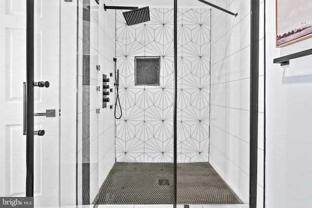 bathroom with a shower with door