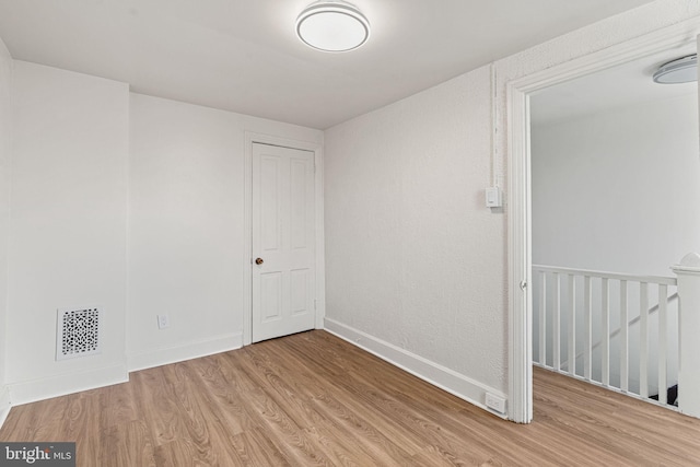 spare room with light hardwood / wood-style floors