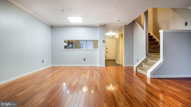 interior space featuring hardwood / wood-style flooring, sink, and crown molding