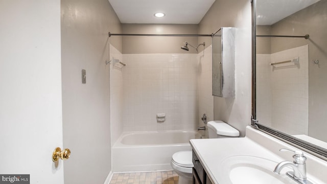 full bathroom with vanity, tiled shower / bath, and toilet