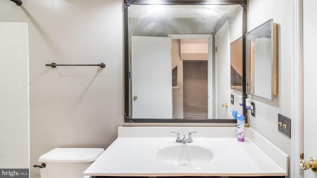 bathroom featuring vanity and toilet