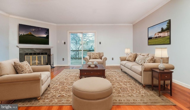 living room with crown molding and hardwood / wood-style flooring