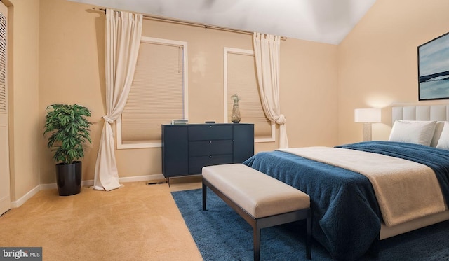 carpeted bedroom featuring vaulted ceiling