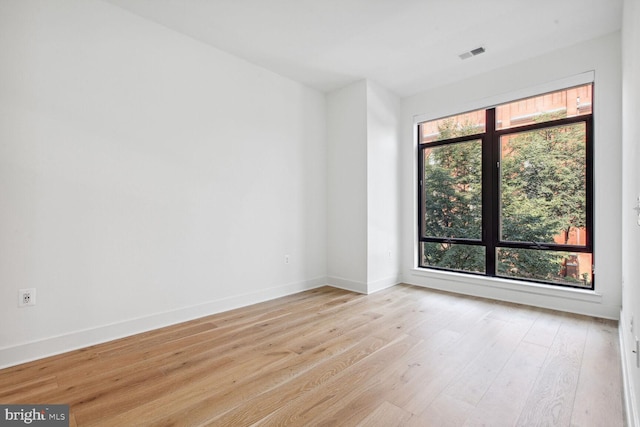 empty room with light hardwood / wood-style flooring