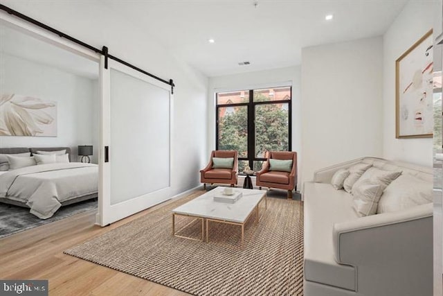 living room featuring hardwood / wood-style flooring and a barn door