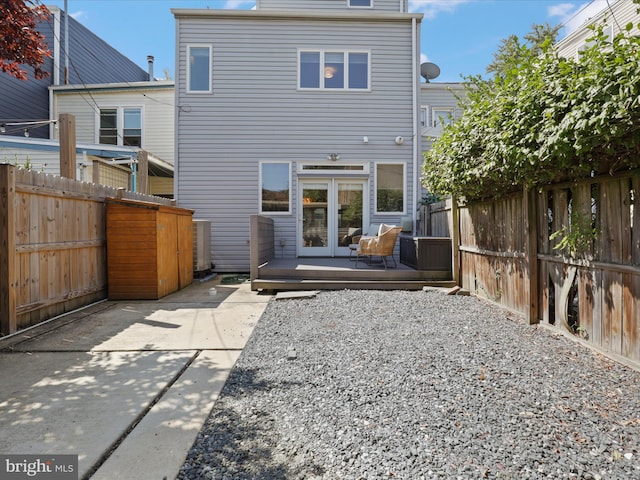 back of property featuring a patio area and a wooden deck